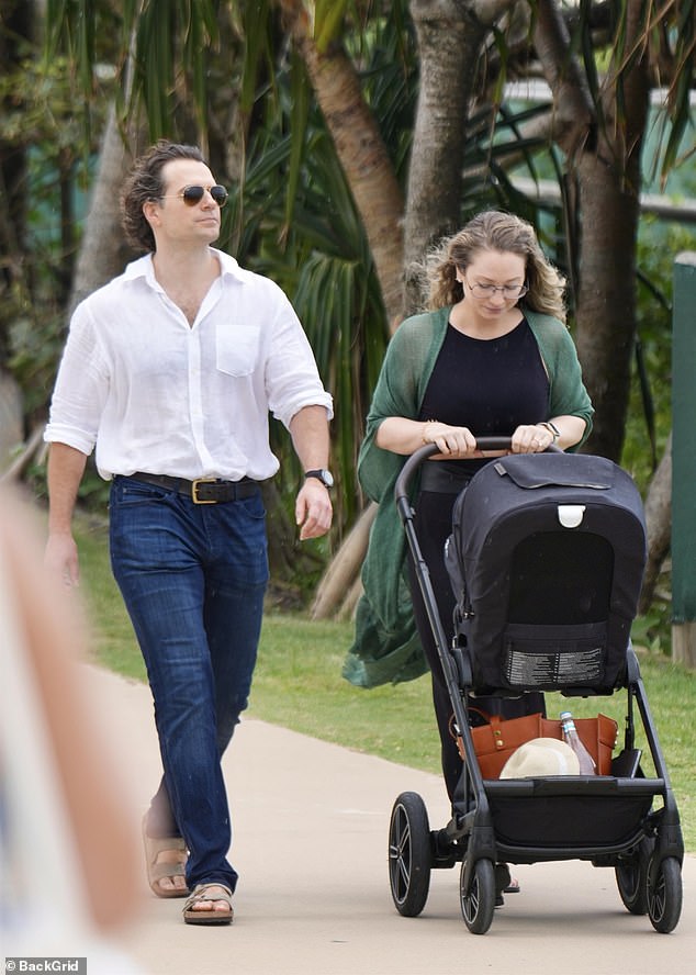 Natalie kept things casual in a black boho maxi dress over which she had on a flowing green cardigan, adding black flip flops