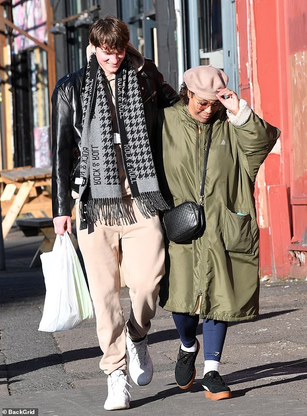 The besotted couple were all smiles as they carried back a bag of food from the shops with their arms wrapped around each other