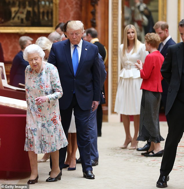 Queen Elizabeth II and Donald Trump pictured together at Buckingham Palace, with Ivanka Trump seen speaking with Prince Harry behind them in June 2019