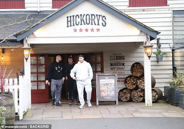 The athlete was pictured leaving Hickory's Smokehouse in Wilmslow with his pals