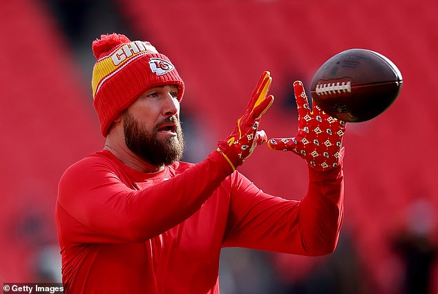 Travis Kelce warms up on the field before kickoff on a bitterly cold day in Kansas City