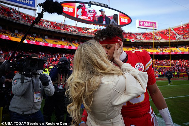 The couple, who recently celebrated the birth of their third child, shared a kiss on the field