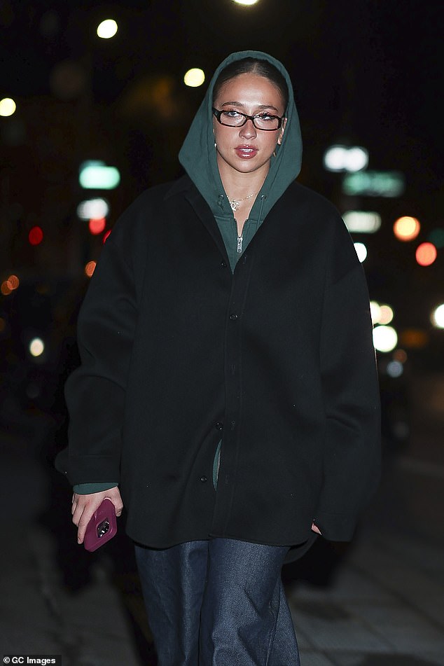 Tate layered up with a black zip-up jacket for the couple's walk through chilly NYC