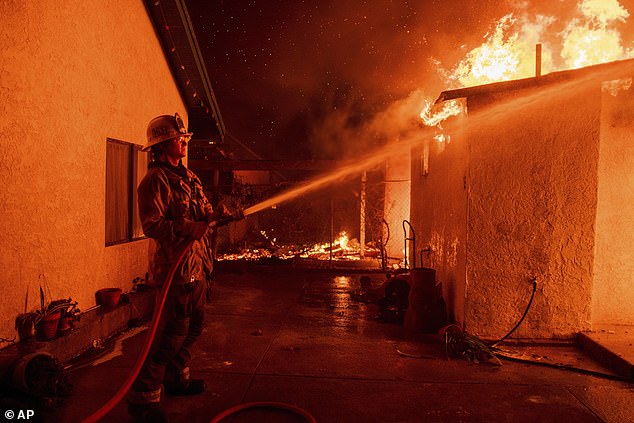 Six fires have erupted across the greater LA area since Januay 7. As of Friday evening, firefighters are still battling the Palisades Fire as well as the Eaton and Hurst fires. Pictured: A firefighter sprays water on a garage burning in the Eaton Fire in Altadena, California