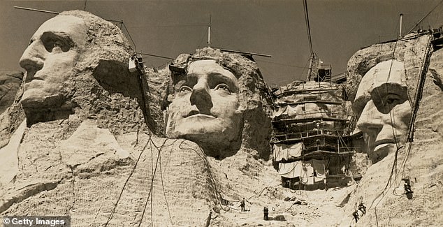 Workmen on the faces of Mount Rushmore, Pennington County, South Dakota seen in the late 1930s. Roosevelt has the scaffolding over his face