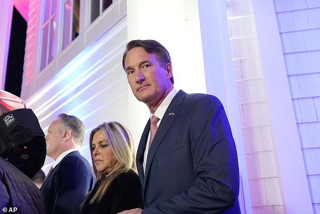 Glenn Youngkin walks inside after watching fireworks at Trump National Golf Club