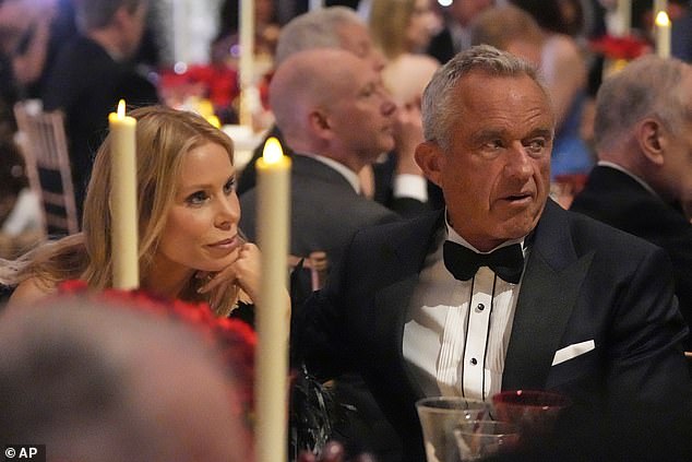 Robert F. Kennedy Jr., right, and his wife, Cheryl Hines, left, listen as Vice President-elect JD Vance speaks during a dinner event at the National Gallery of Art in Washington