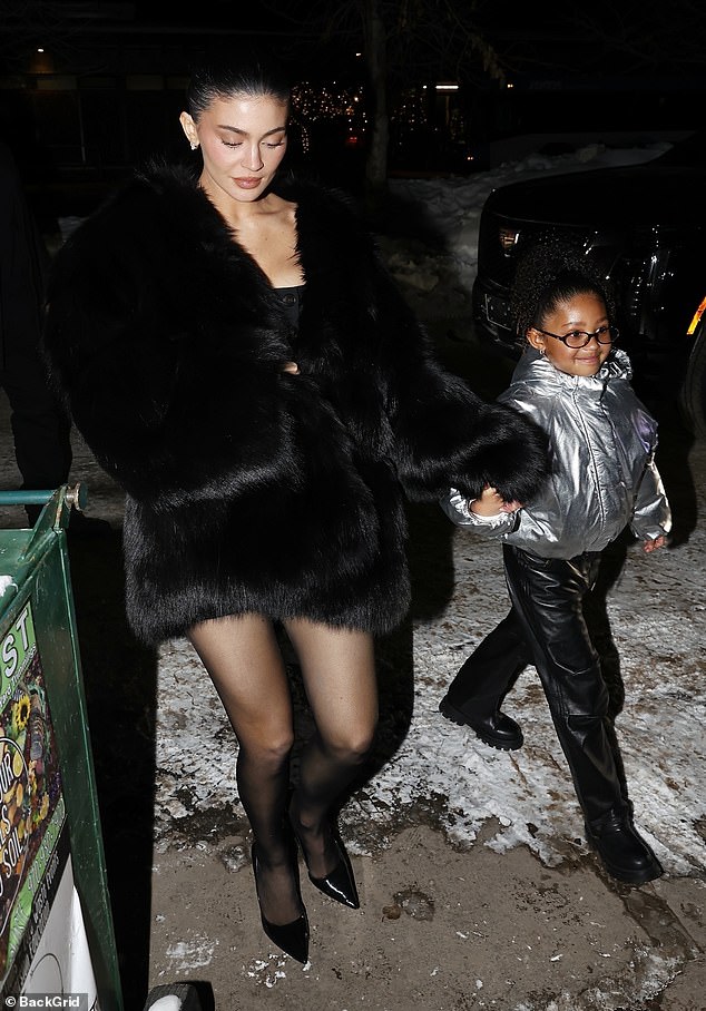 Kylie Jenner braved the cold in a sexy outfit as she held hands with her daughter Stormi, six, while heading to dinner with her sister Kendall in Aspen on Saturday night