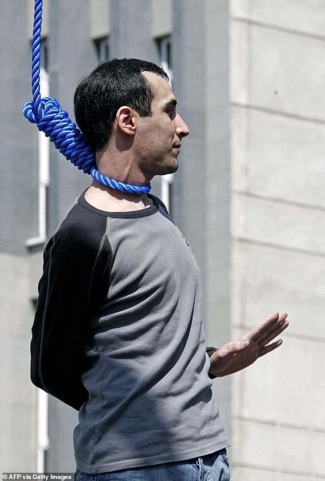 Majid Kavousifar bids farewell to his relatives before being hanged in public in central Tehran on August 2, 2007