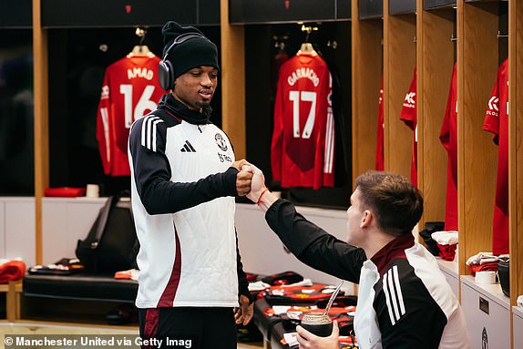 MANCHESTER, ENGLAND - JANUARY 19: Amad Diallo and Manuel Ugarte of Manchester United interact inside the Manchester United dressing room prior to the Premier League match between Manchester United FC and Brighton & Hove Albion FC at Old Trafford on January 19, 2025 in Manchester, England. (Photo by Ash Donelon/Manchester United via Getty Images)