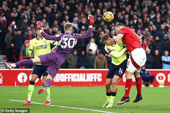 NOTTINGHAM, ENGLAND - JANUARY 19: Chris Wood of Nottingham Forest shoots, which is saved by Aaron Ramsdale of Southampton during the Premier League match between Nottingham Forest FC and Southampton FC at City Ground on January 19, 2025 in Nottingham, England. (Photo by Dan Istitene/Getty Images)