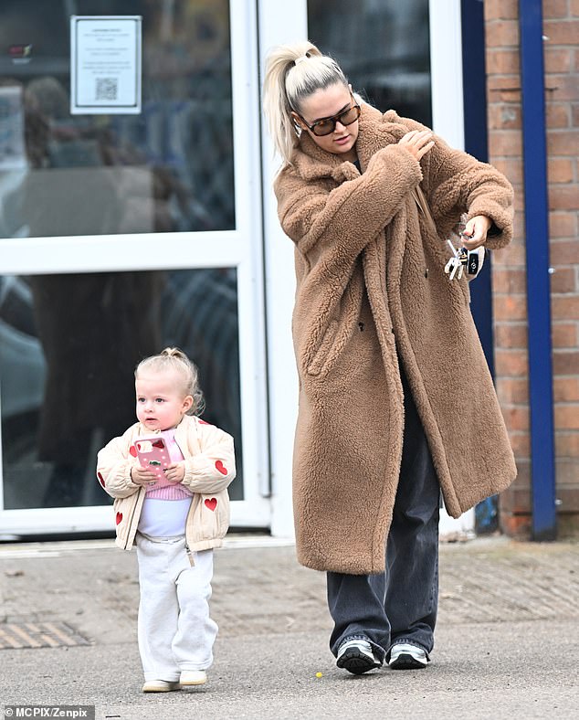 Molly-Mae layered the coat over over black jeans and a simple sweater