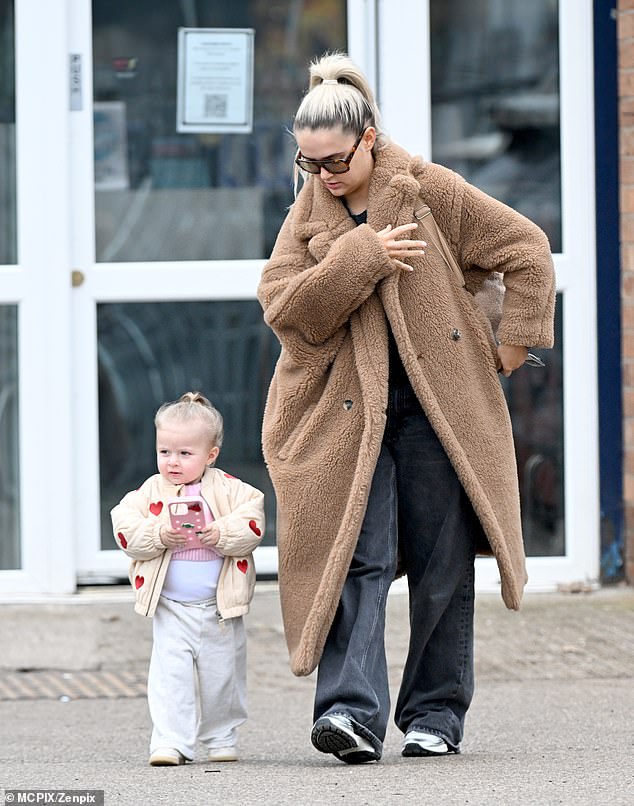 She slipped her feet into a pair of comfy silver trainers and toted her essentials in a backpack