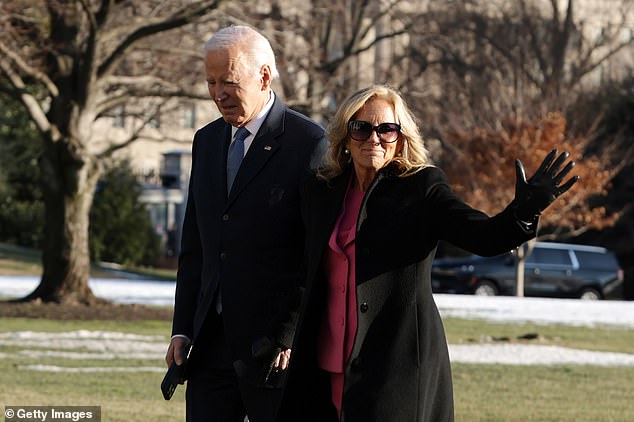 U.S. President Joe Biden and first lady Jill Biden walk on the South Lawn after they returned to the White House