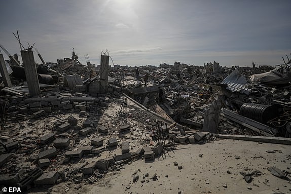 epa11836488 Internally displaced Palestinians inspect their destroyed houses in Rafah town, in the southern Gaza Strip, 19 January 2025. Israel and Hamas agreed on a hostage release deal and a Gaza ceasefire to be implemented on 19 January 2025. More than 46,000 Palestinians have been killed in the Gaza Strip, according to the Palestinian Ministry of Health, since Israel launched a military campaign in the strip in response to a cross-border attack led by the Palestinian militant group Hamas on 07 October 2023, in which about 1,200 Israelis were killed and more than 250 taken hostage.  EPA/MOHAMMED SABER