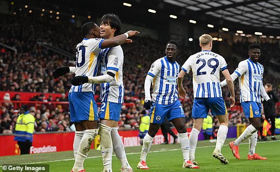 MANCHESTER, ENGLAND - JANUARY 19: Kaoru Mitoma of Brighton & Hove Albion celebrates scoring his team's second goal with teammate Pervis Estupinan during the Premier League match between Manchester United FC and Brighton & Hove Albion FC at Old Trafford on January 19, 2025 in Manchester, England. (Photo by Gareth Copley/Getty Images)