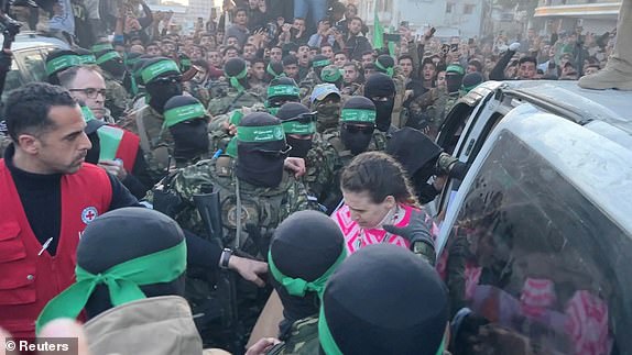 Palestinian Hamas militants hand over hostages kidnapped during the October 7, 2023, attack on Israel by Hamas, to members of the International Committee of the Red Cross (ICRC) as part of a ceasefire and a hostages-prisoners swap deal between Hamas and Israel, in Gaza City, January 19, 2025 in this screen grab from a video. REUTERS/Reuters TV