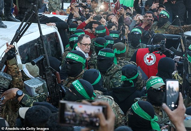 Al-Qassam Brigades hands over three Israeli hostages to Red Cross at al-Saraya as part of the first phase of the ceasefire and prisoner swap deal between Israel and Hamas, in Gaza City