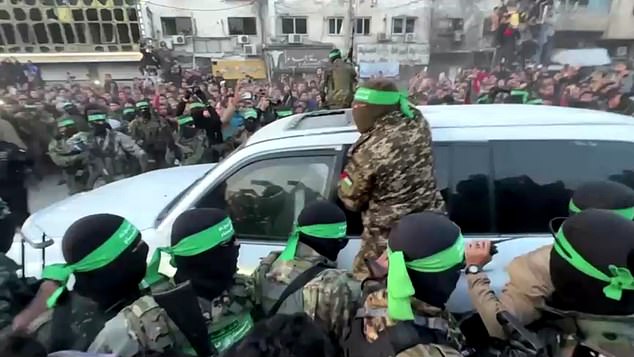 In one video, dozens of heavily armed Hamas fighters are heard shouting at Gazan crowds and shoving them away as the white van attempts to cut through