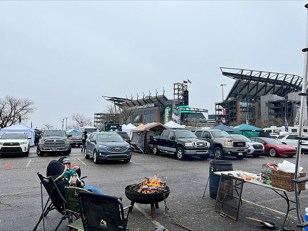 Eagles supporters huddle around a fire in the freezing temperatures on Sunday morning