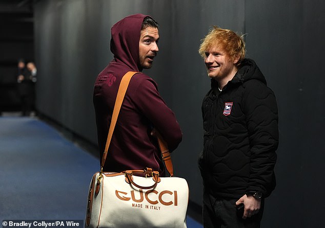 Ed wrapped up warm in a black padded jacket emblonzed with the Ipswich badge as he shook hands and shared a hug with his famous friend