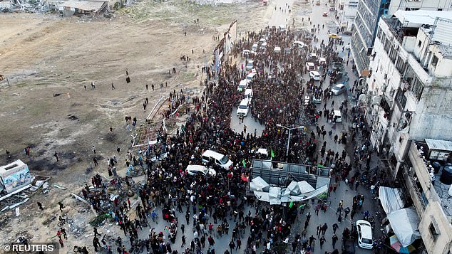 A drone view shows people gathering as Palestinian Hamas militants prepared for the handover of the hostages