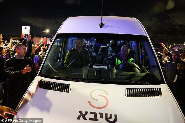 Members of the Israeli security and medical personnel transport the three hostages upon their arrival at Sheba Tel HaShomer Medical Center in Ramat Gan