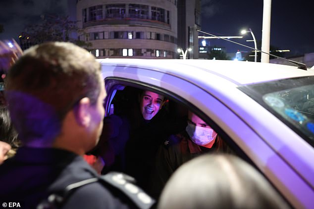 Emily Damari greets friends and supporters as she arrives at hospital