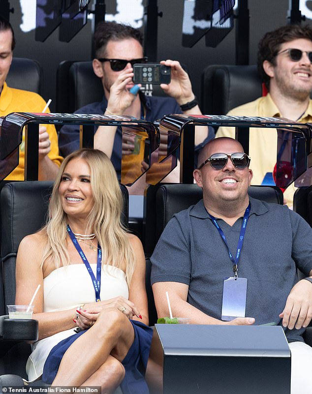 Later, she posed up a storm in the stands on Rod Laver Arena while watching a match with a male friend