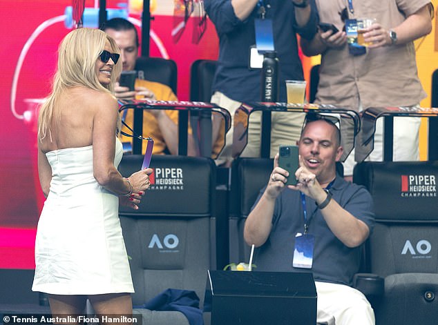 The Dancing with the Stars host slipped on a pair of oversized shades and posed against the backdrop of the court between games