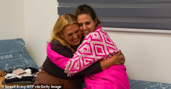 This handout picture released by the Israeli army shows former Israeli hostage Doron Steinbracher with her mother Simone at an undisclosed location in Israel on January 19, 2025 after a ceasefire and hostage-prisoner exchange deal in the war between Israel and Hamas was implemented. The first three Israeli hostages were released on January 19 under a long-awaited Gaza truce aimed at ending more than 15 months of war that has ravaged the Palestinian territory. The Hostage and Missing Families Forum campaign group had identified the three women set to be released as Emily Damari, Romi Gonen and Doron Steinbrecher. (Photo by Israeli Army / AFP) / === RESTRICTED TO EDITORIAL USE - MANDATORY CREDIT "AFP PHOTO / Handout / Israeli Army' - NO MARKETING NO ADVERTISING CAMPAIGNS - DISTRIBUTED AS A SERVICE TO CLIENTS == (Photo by -/Israeli Army/AFP via Getty Images)