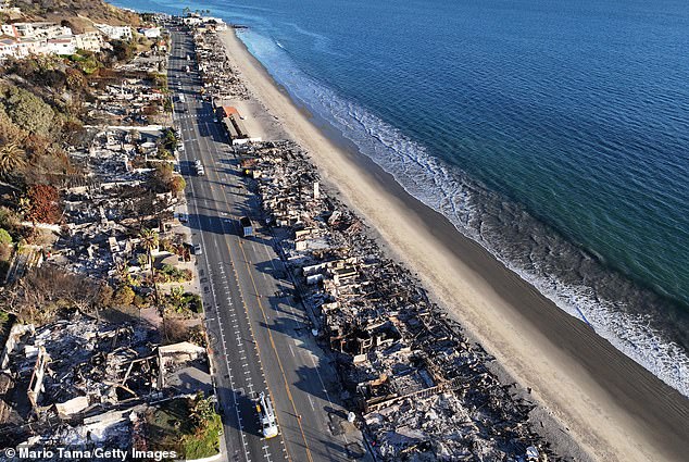 Officials have confirmed 27 deaths, over 13,600 destroyed structures, thousands remain evacuated, and economic loss is estimated to cost between $135B-$150B (Pacific Palisades pictured last Thursday)