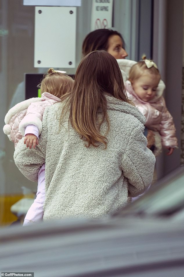 Dani was seen carrying in her twin daughters Summer and Star, 20 months, inside the venue