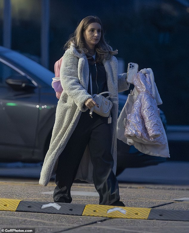 Dani headed home clutching her daughters' belongings after a fun day out at soft play