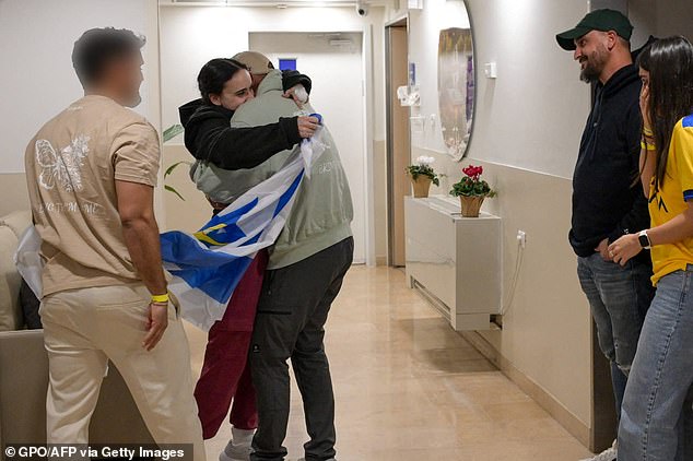 Wrapped in an Israeli flag, Emily leapt into the arms of her family at the hospital