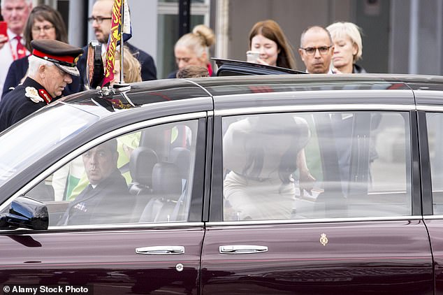 In this picture, Meghan can been seen entering the car first and moving along to sit behind the front passenger