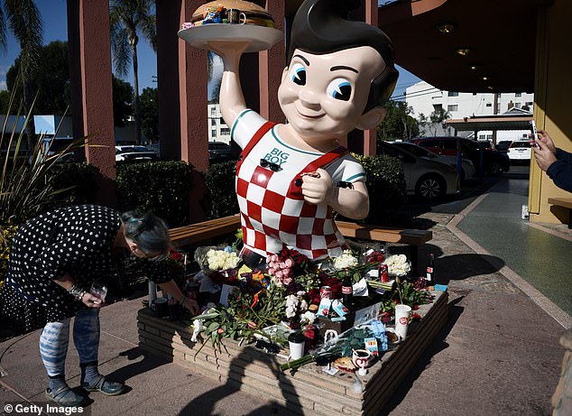 The five feet Big Boy statue in Burbank has become a shrine to Lynch, with fans leaving red roses, candles, cigars, coffee mugs and Coca Cola bottles on it