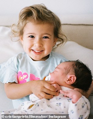 Another showed Ona, in big sister mode, happily posing for the camera as she carefully cradled the cherubic bub