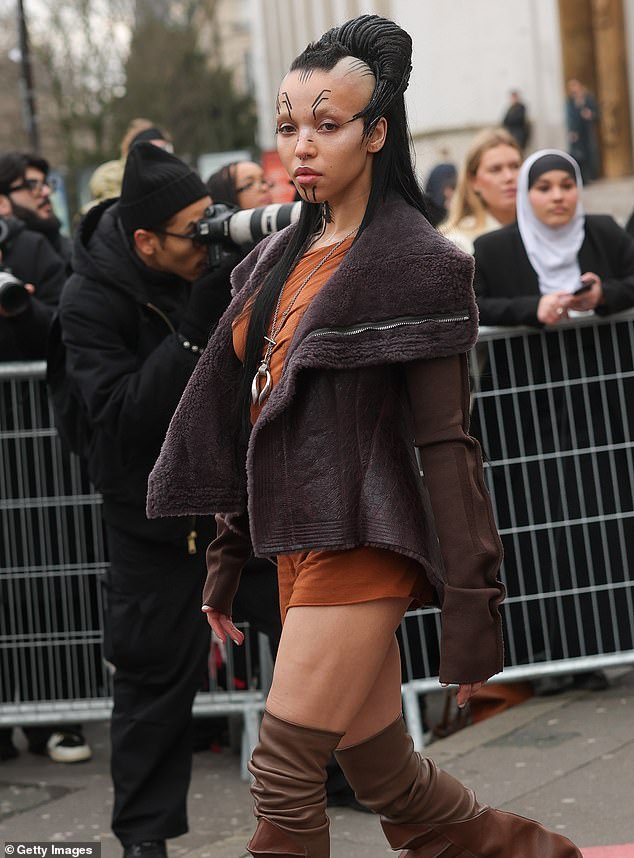 The singer, whose third album Eusexua comes out on Friday, also wore a burnt orange mini dress and kept warm with a brown leather jacket with a purple fur lining