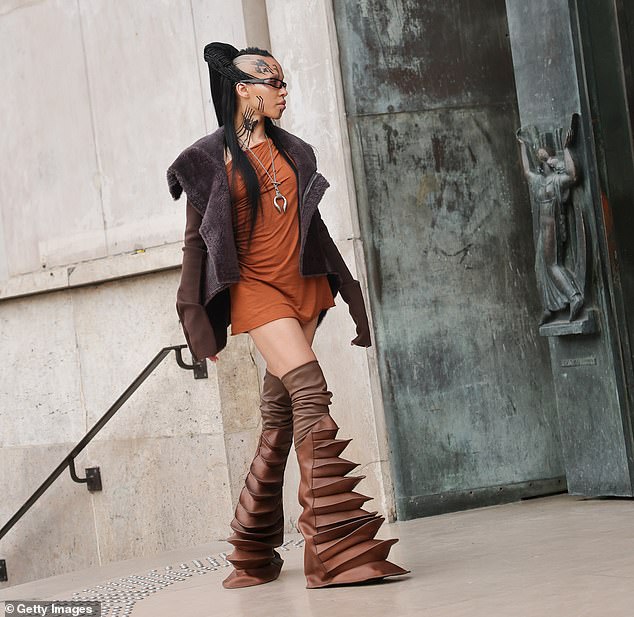 The English singer, 37, whose real name is Tahliah Debrett Barnett, posed in a pair of brown boots, described as 'rhino' shoes by designer Rick Owens whose show she was attending