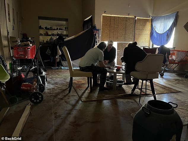 Heaps of prescription drugs and garbage, shopping carts, beer bottles and food remnants are seen scattered across the abandoned floors