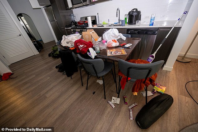 The kitchen table, strewn with clutter, some of which spilled onto the floor along with pieces of chocolate