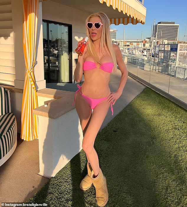 Brandi Glanville, 52, showed off her age-defying figure in a bright pink bikini in a stunning Instagram snap in Los Angeles on Thursday