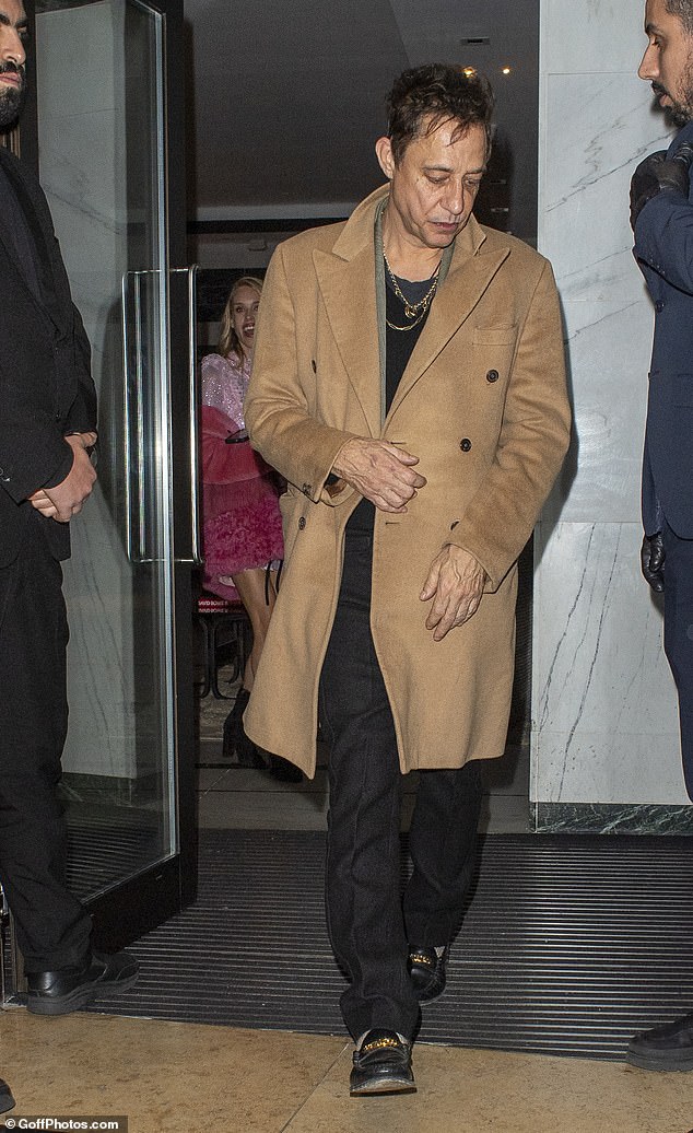 Jamie left the party solo and looked dapper in a tan coat layered over a black jumper and trousers with brogues