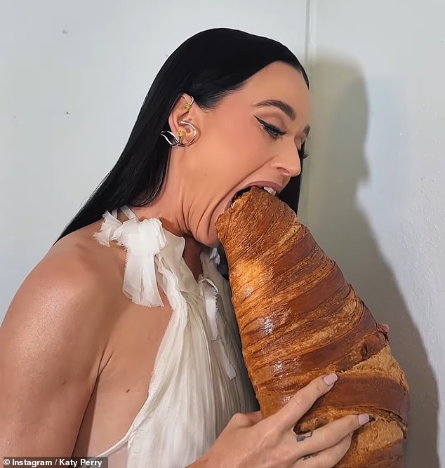 As part of her sightseeing, Katy decided to get her hands on an enormous croissant, which she cradled like a baby before filming herself tucking into the French delicacy