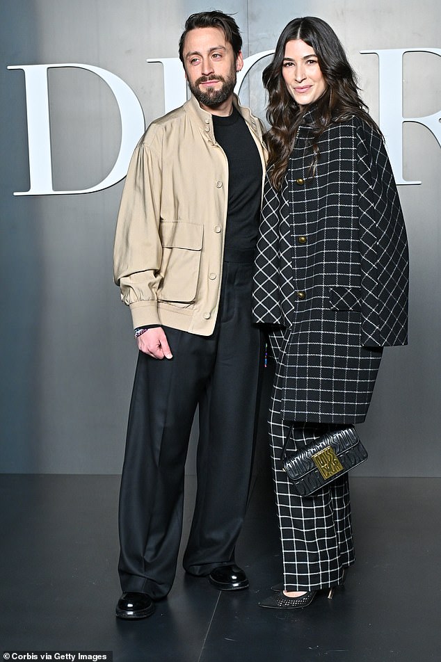 The Succession star, 42, donned a tan bomber jacket while his wife looked glamorous in a black and white patterned suit