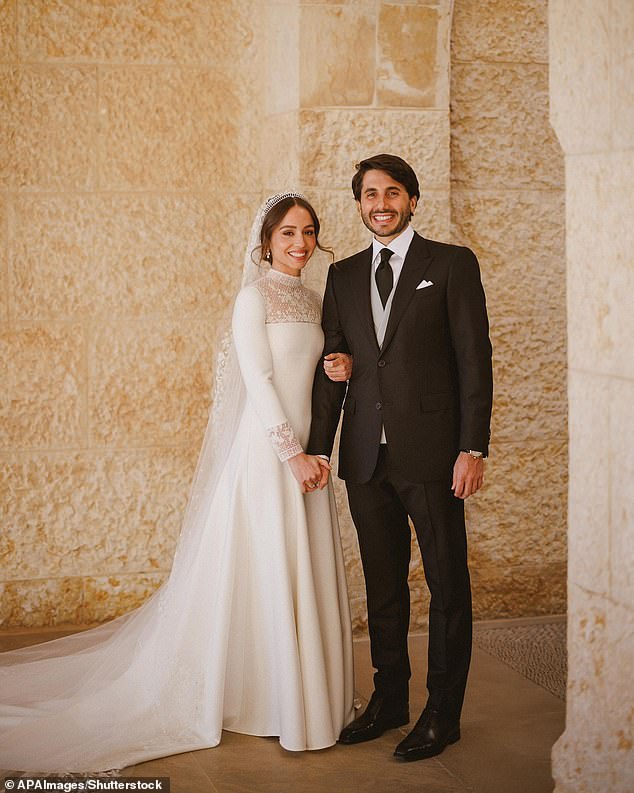 The royal's mother, Queen Rania , 54, took to Instagram on Friday, where she shared an adorable picture of the pair stood together at sunset, with Iman proudly showing off the silhouette of her small bump (pictured on their wedding day in 2023)