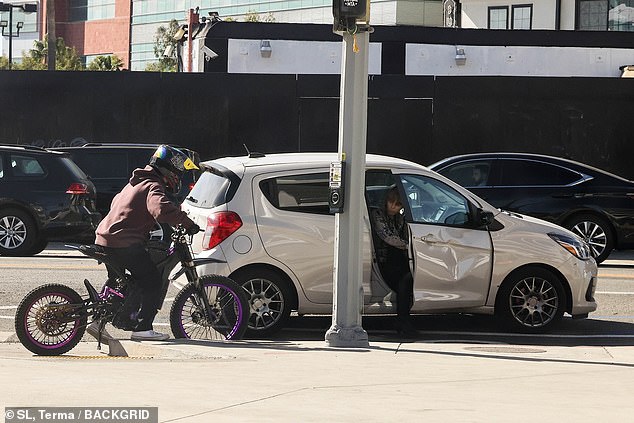 The budding photographer was driving his purple-and-black two-wheeler when he smashed into a white hatch-back car just before noon. The dent can be seen on the door