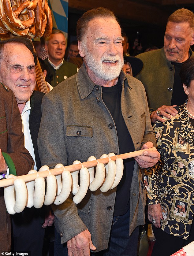 The Hollywood actor, 77, proudly held up a string of traditional white sausages as he tucked in at the annual Weißwurstparty in Going in his home country