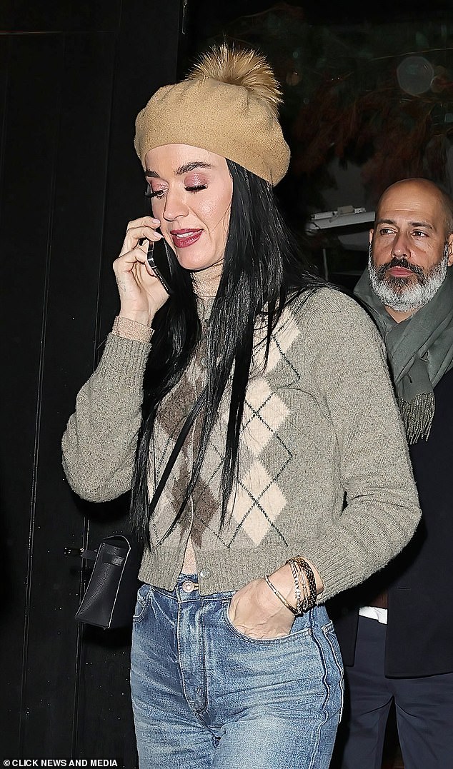 Katy acessorized with a fluffy brown beret and a black crossbody mini tote and injected a dose of glamour with a slick of cherry-hued lipstick